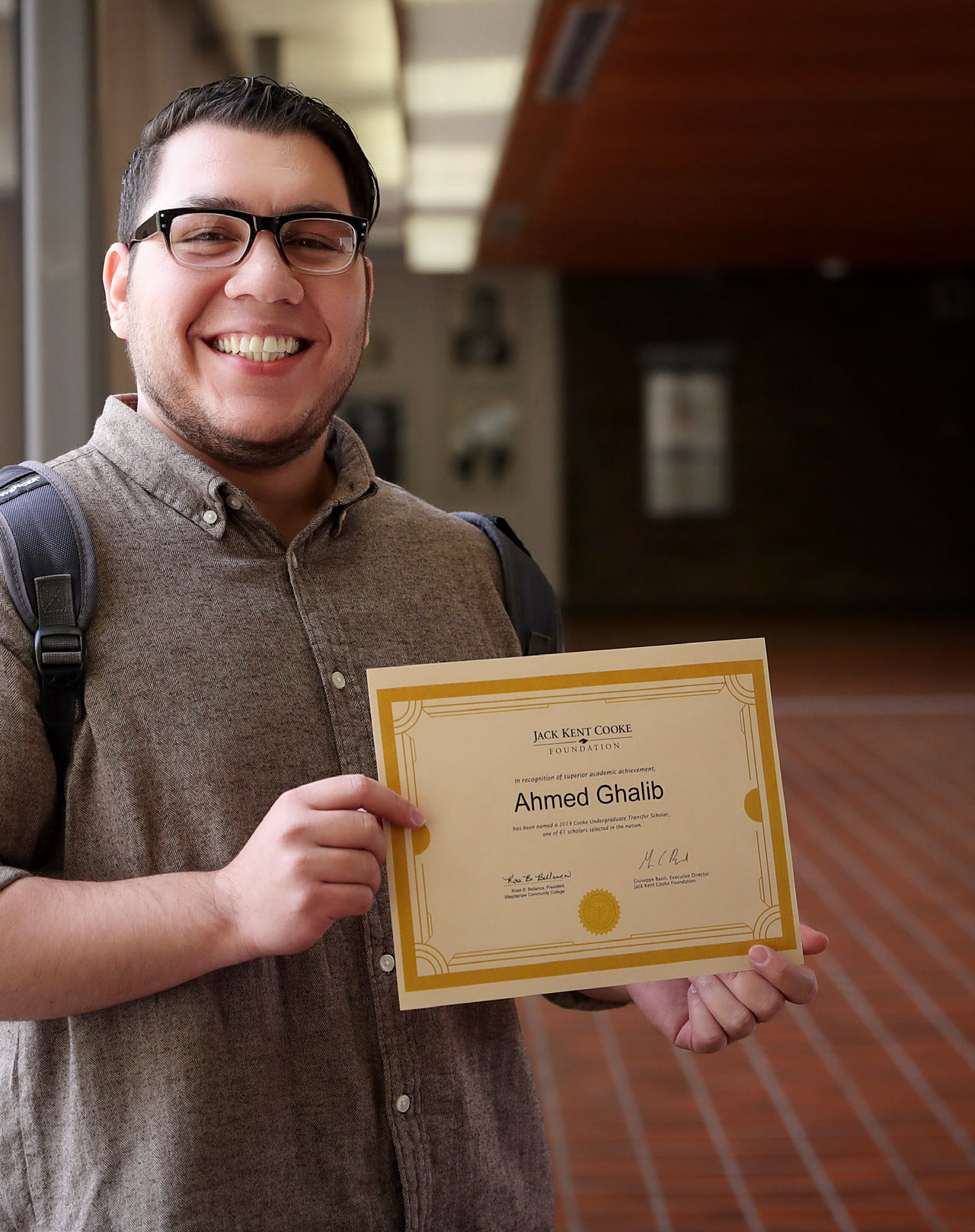 Ahmed Ghalib holding his certificate