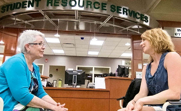 Advisor talking with a student at the Student Resource Center